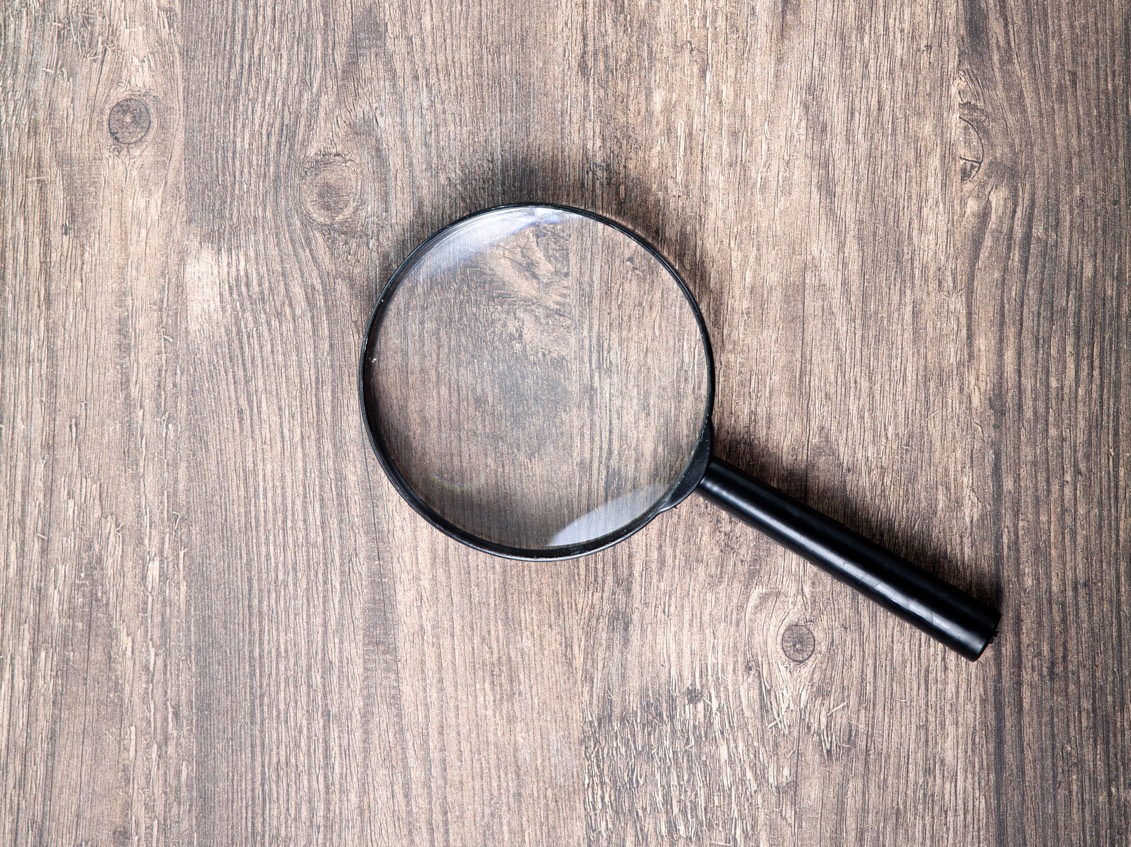 Magnifying glass on wooden table