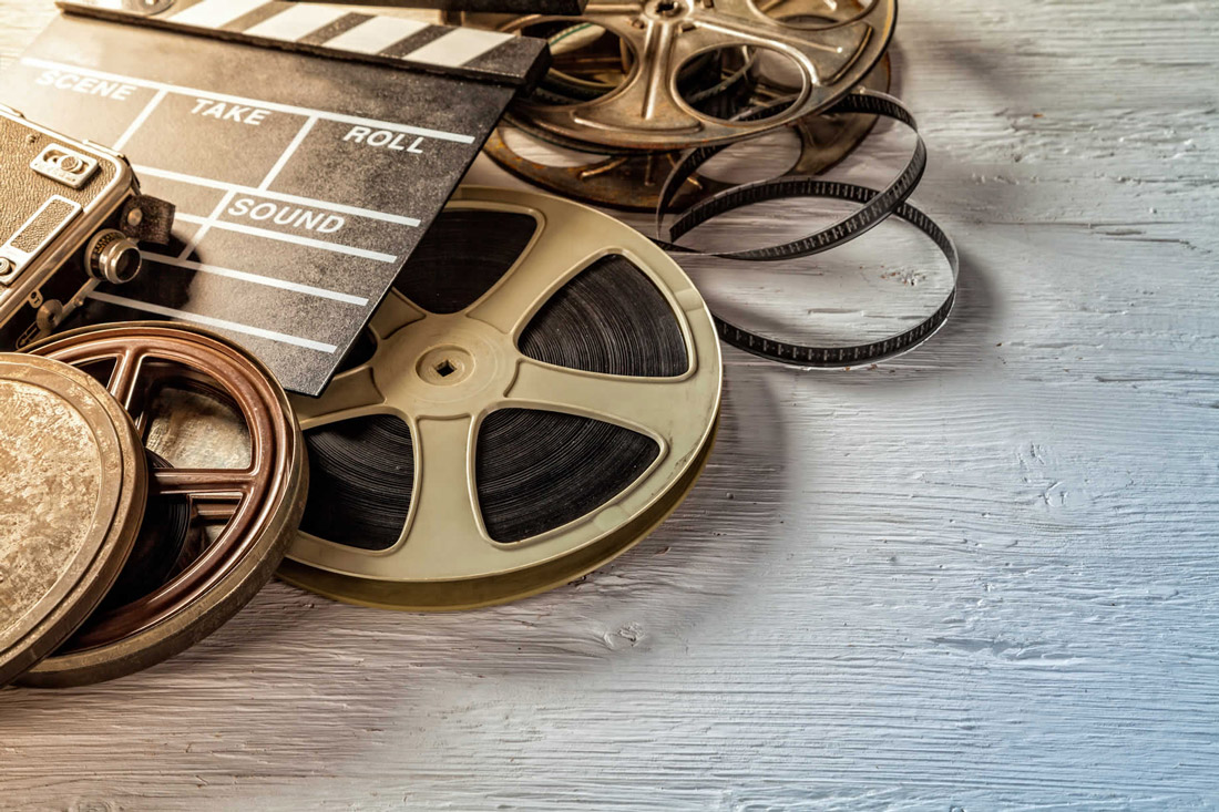 Old video reels with clapboard on top